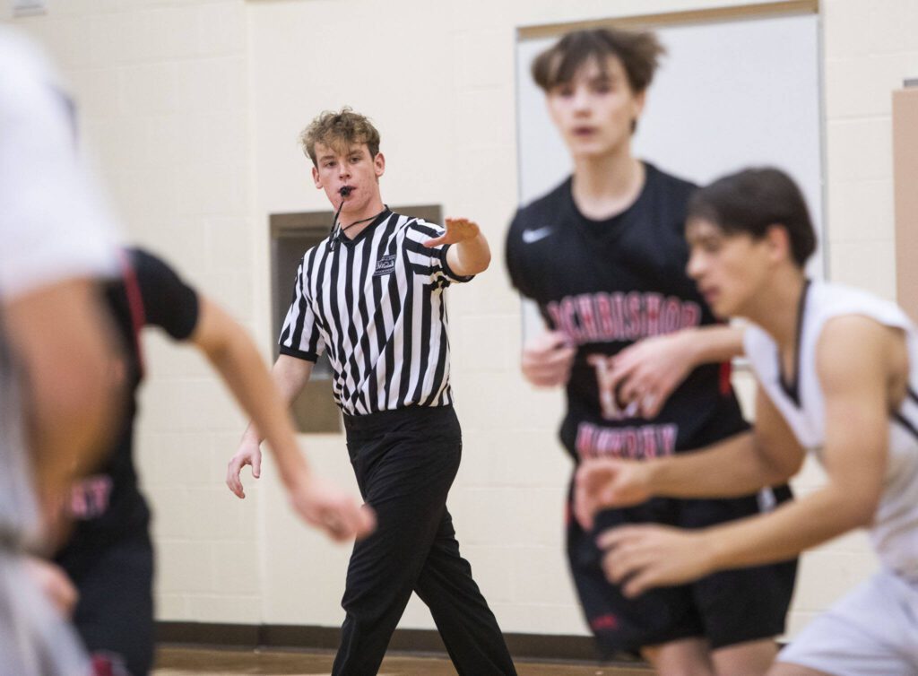 Matthew Meadows referees a game Jan. 16 at Lynnwood High School in Bothell. (Olivia Vanni / The Herald)
