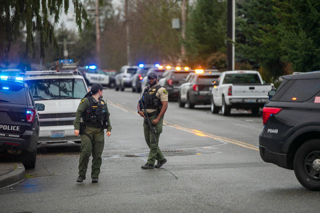 Members of the Snohomish County Sheriff’s Department patrol along Paine Field Way during a police standoff Wednesday, Jan. 31, 2024, in south Everett, Washington. (Ryan Berry / The Herald)
