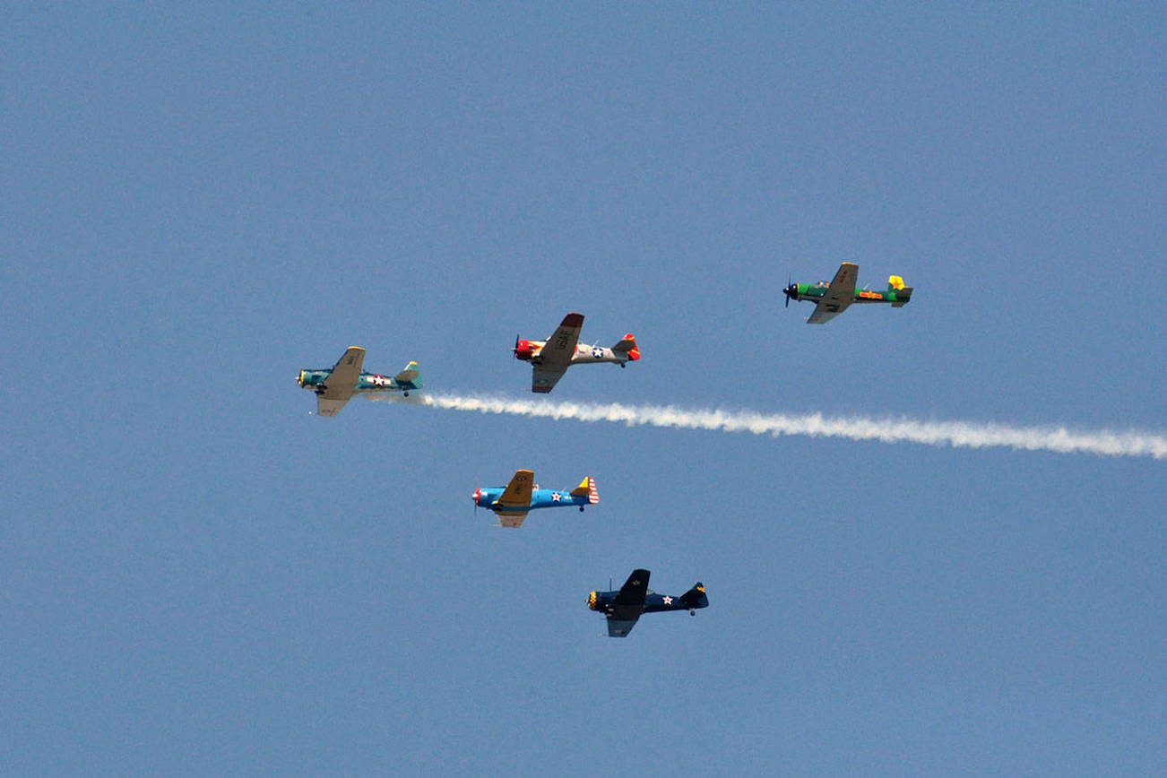 The Cascade Warbirds fly over Naval Station Everett. (Sue Misao / The Herald file)