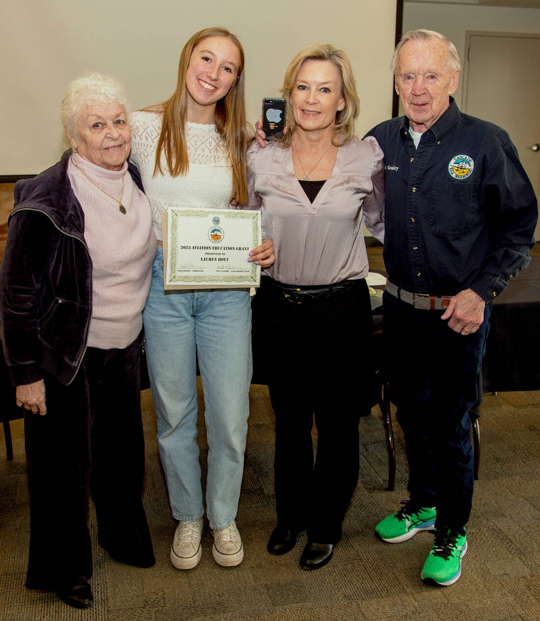 Bothell High School senior Lauren Hoyt is the 2023 recipient of Cascade Warbirds' $2,500 Continuing Aviation. Hoyt, center, holds her award. She is flanked by grandmother Carol Granley, left, and mother Debbie Hoyt, a commercial airline pilot, right, and grandfather pilot Bud Granley, far right. (Cascade Warbirds: January 13, 2024, Museum of Flight, Seattle)