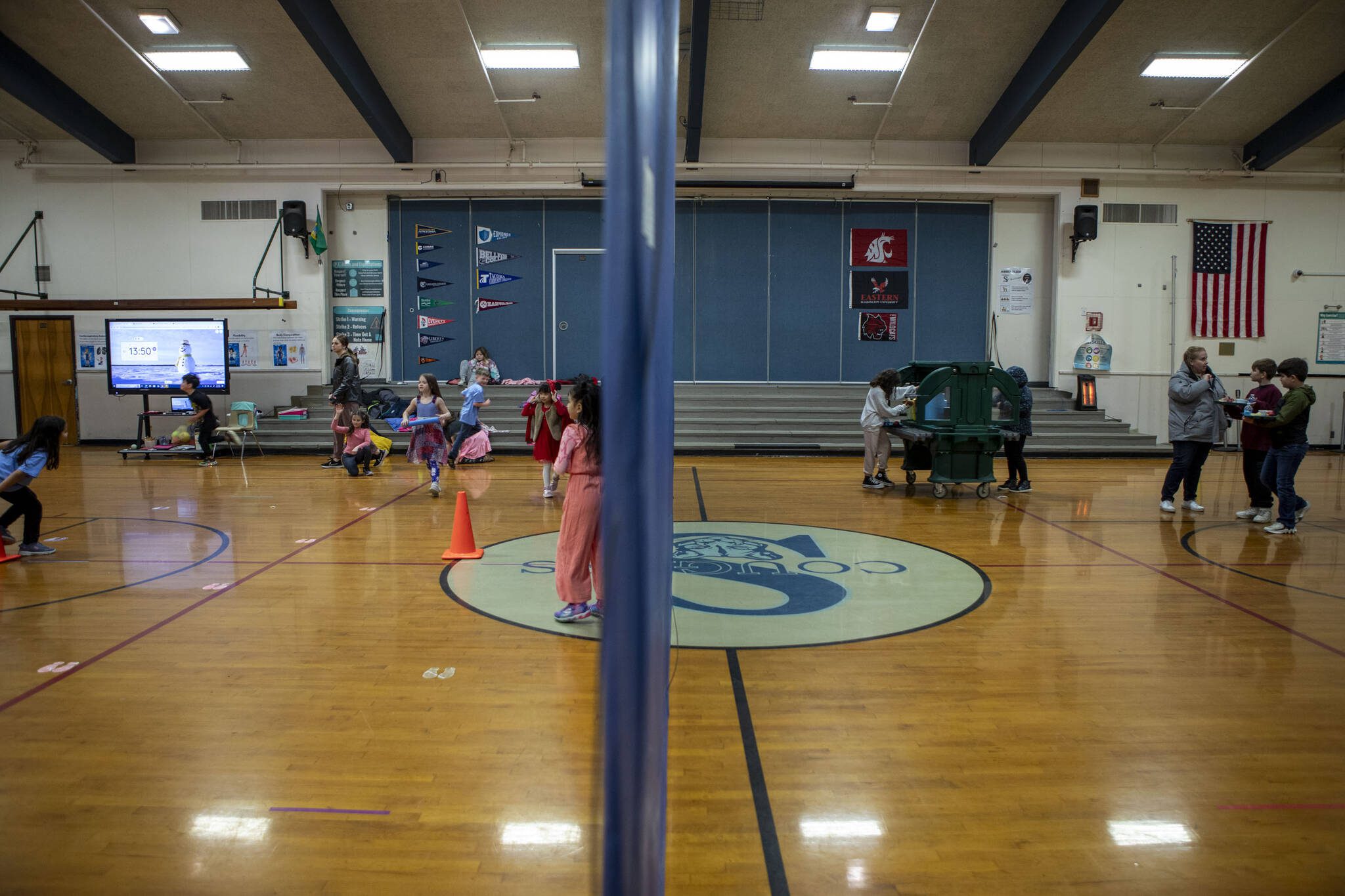 Half of a gym is used for physical education class while the other serves as a makeshift lunch station at the Sultan Elementary School on Wednesday, Jan. 24, 2024 in Sultan, Washington. Students have to walk to the gym to pick up food and then eat in their classrooms. (Annie Barker / The Herald)