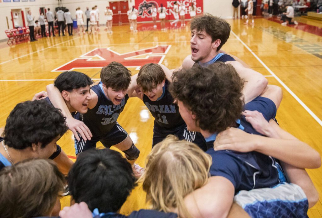 Toby Trichler, right, yells during a team cheer before the start of the game on Jan. 23 in Shoreline. (Olivia Vanni / The Herald)
