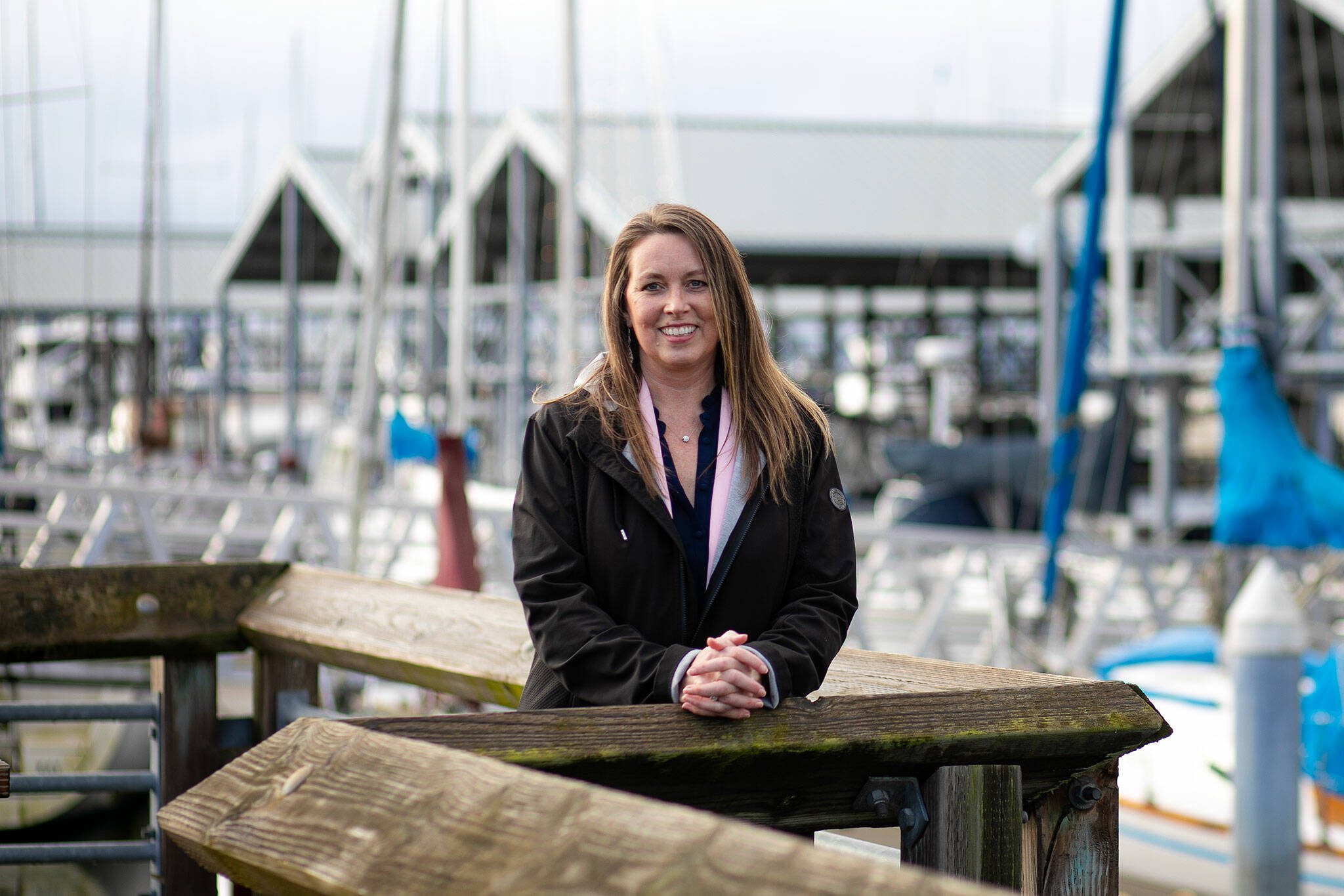 Angela Harris, Executive Director of the Port of Edmonds, stands at the port’s marina on Wednesday, Jan. 24, 2024, in Edmonds, Washington. (Ryan Berry / The Herald)