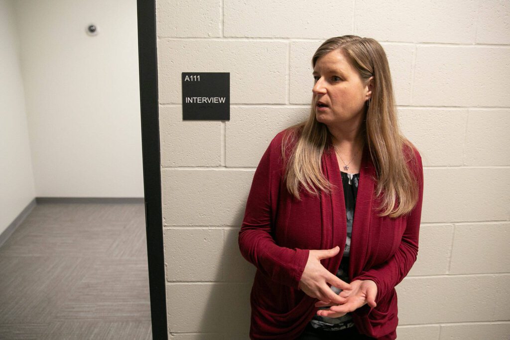 Danielle Singson, domestic violence prevention coordinator for the Mountlake Terrace Police Department, stands outside a standard interview room at the Mountlake Terrace Police Department on Tuesday, Jan. 30, 2024, in Mountlake Terrace, Washington. (Ryan Berry / The Herald)
