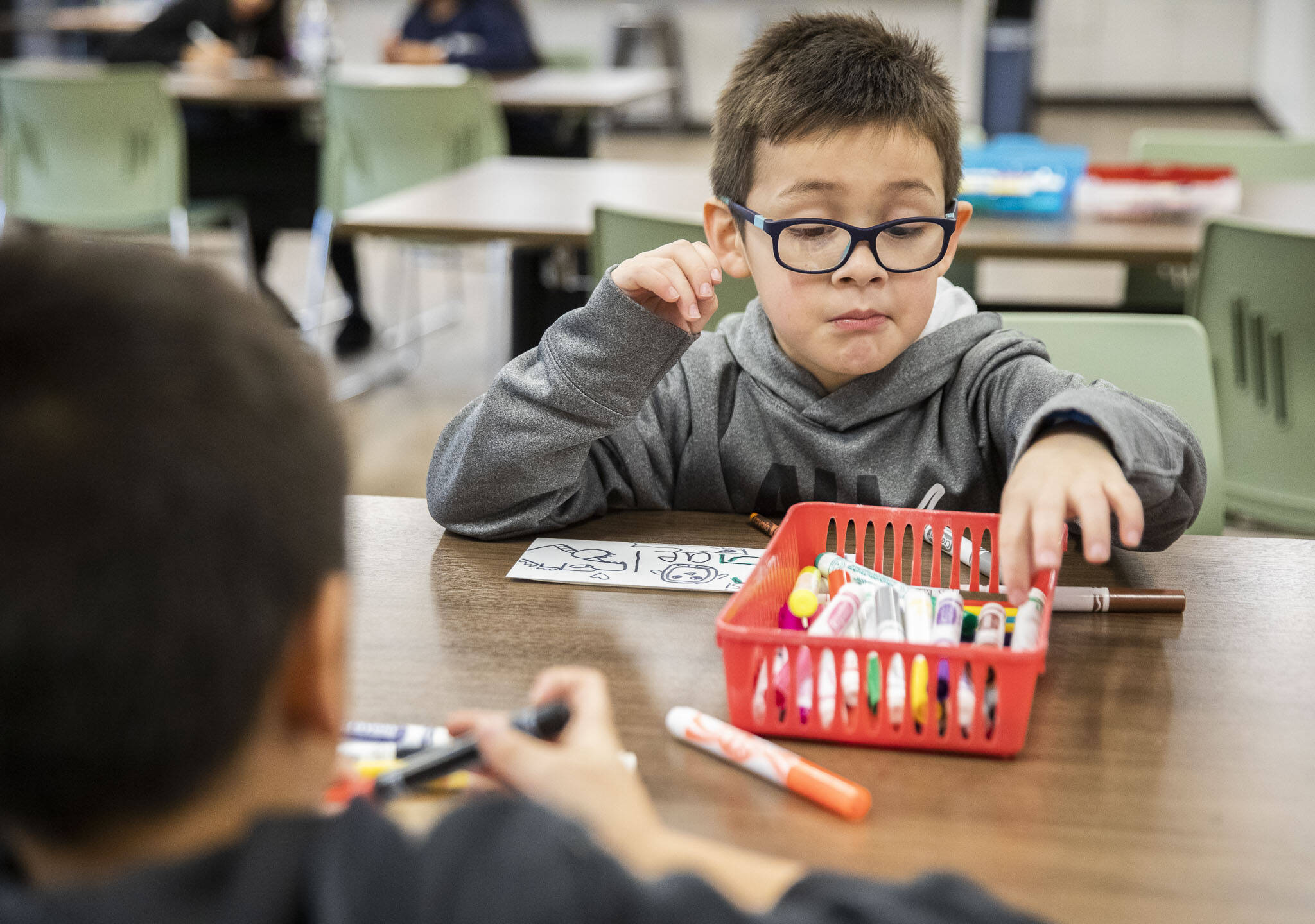 Gael Hernandez looks for a marker while drawing during a new free after-school program at Connect Casino Road on Monday, Jan. 29, 2024 in Everett, Washington. (Olivia Vanni / The Herald)