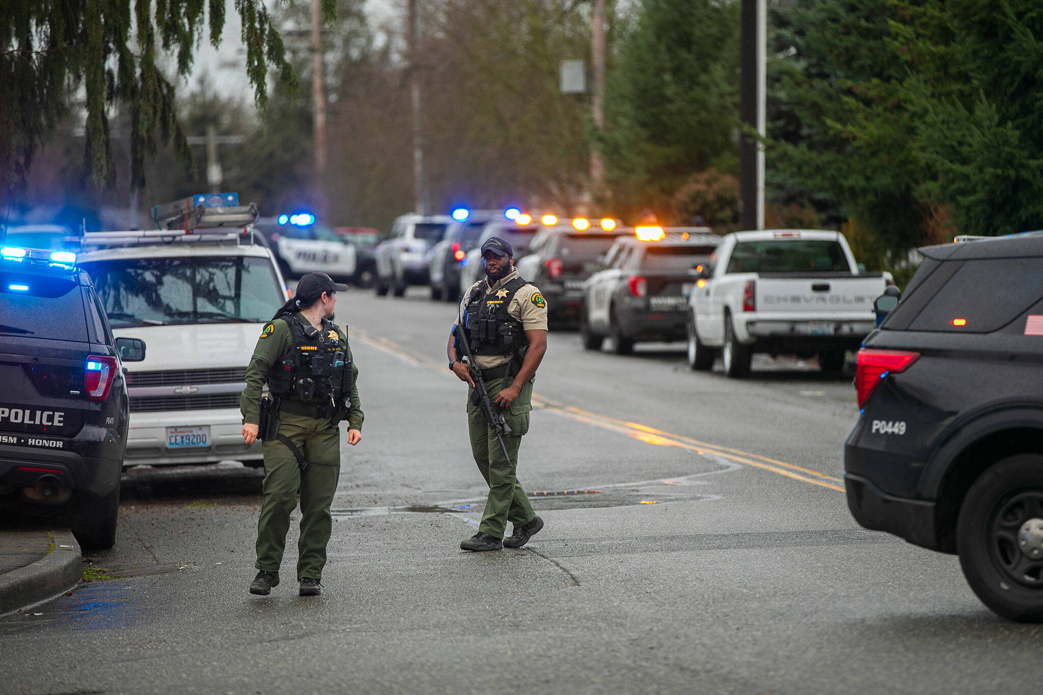 Members of the Snohomish County Sheriff’s Office patrol along Paine Field Way during a police standoff Wednesday, Jan. 31, 2024, in south Everett, Washington. (Ryan Berry / The Herald)