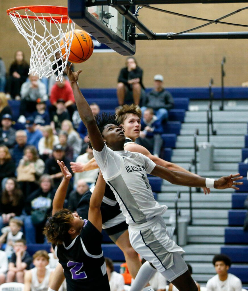 Glacier Peak senior Adam Loum scores from under the basket against Kamiak during a 4A boys basketball game on Thursday, Feb. 1, 2024, at Glacier Peak High School in Snohomish, Washington. (Ryan Berry / The Herald)
