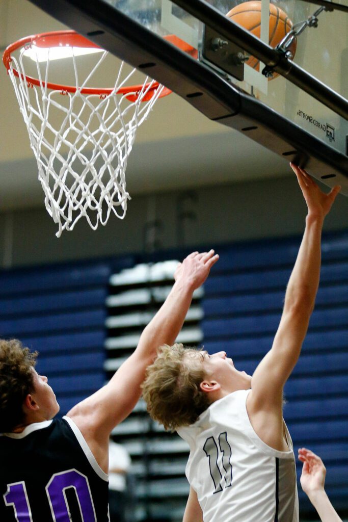 Glacier Peak sophomore Reed Nagel finishes a layup in traffic against Kamiak during a 4A boys basketball game on Thursday, Feb. 1, 2024, at Glacier Peak High School in Snohomish, Washington. (Ryan Berry / The Herald)
