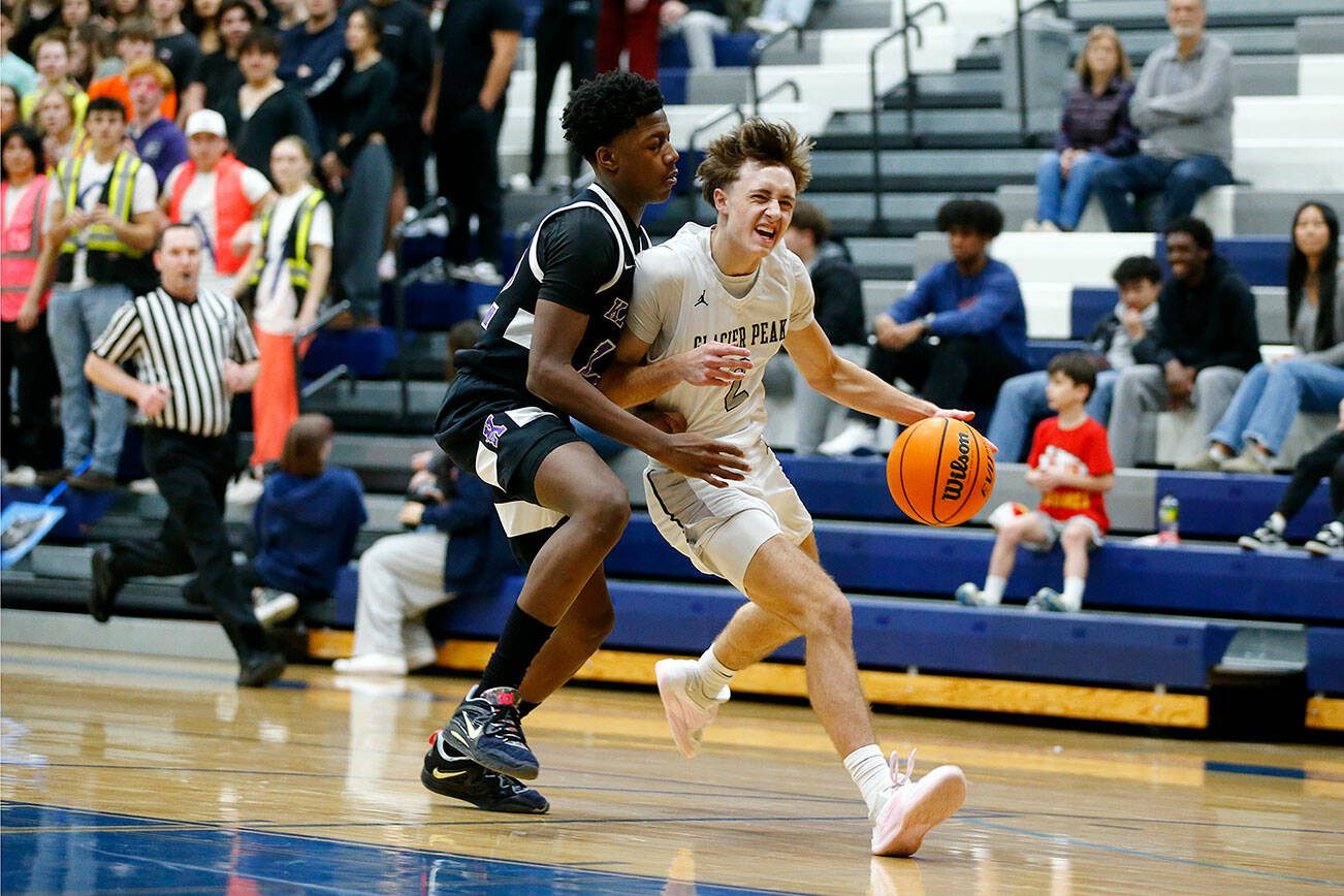 Glacier Peak’s Josiah Lee fights through contact to finish a fast break against Kamiak during a 4A boys basketball game on Thursday, Feb. 1, 2024, at Glacier Peak High School in Snohomish, Washington. (Ryan Berry / The Herald)