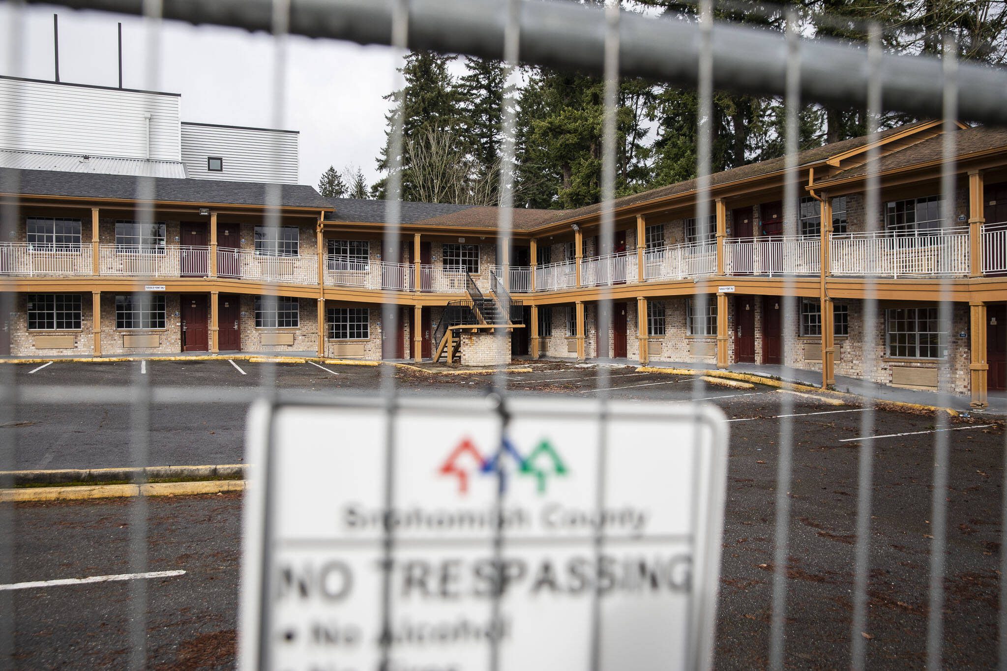 A Snohomish County no trespassing sign hangs on a fence surrounding the Days Inn on Monday, Feb. 12, 2024 in Everett, Washington. (Olivia Vanni / The Herald)
