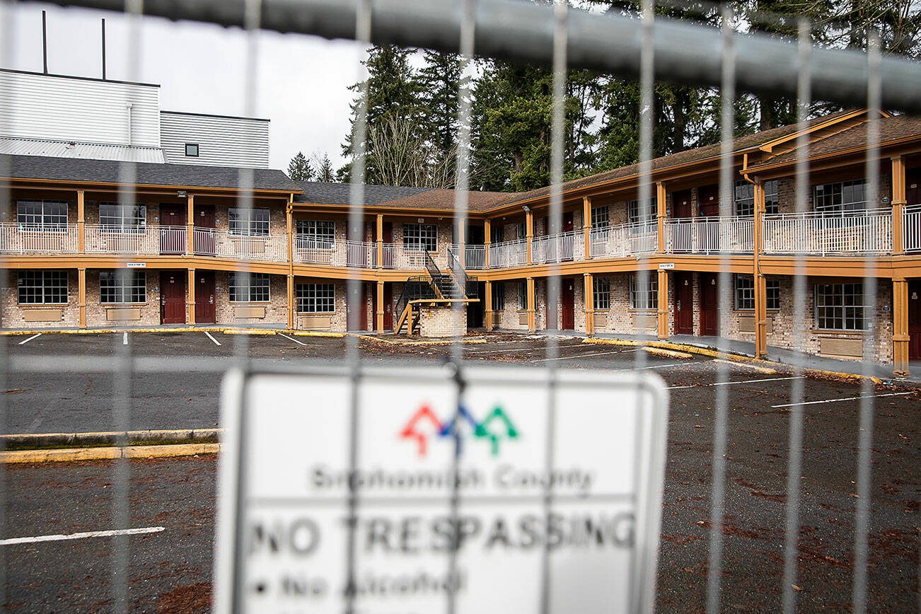 A Snohomish County no trespassing sign hangs on a fence surrounding the Days Inn on Monday, Feb. 12, 2024 in Everett, Washington. (Olivia Vanni / The Herald)