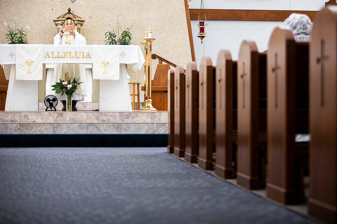 Father Tuan Nguyen holds morning mass at Immaculate Conception Church on Wednesday, May 4, 2022 in Everett, Washington. (Olivia Vanni / The Herald)