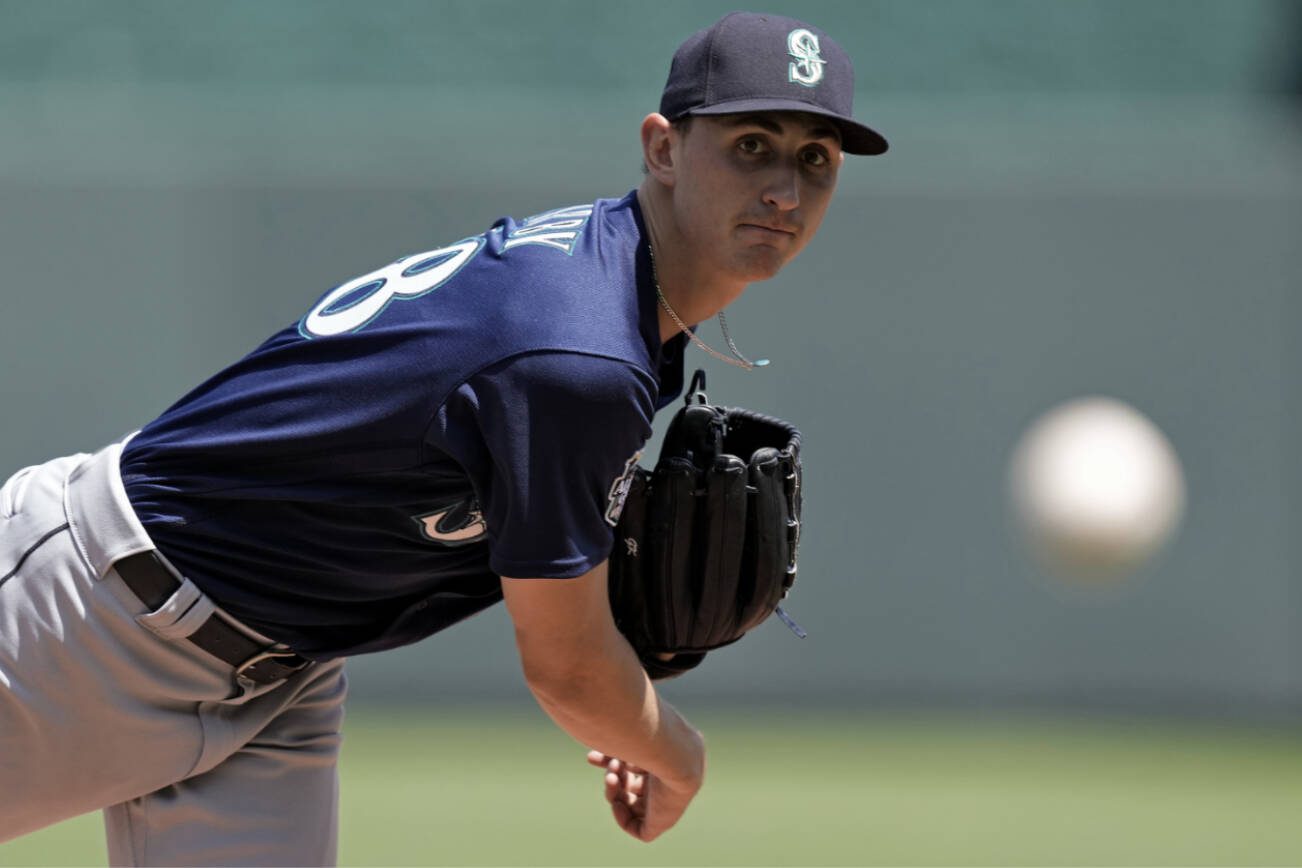 Seattle Mariners starting pitcher George Kirby throws during the first inning of a baseball game against the Kansas City Royals Thursday, Aug. 17, 2023, in Kansas City, Mo. (AP Photo/Charlie Riedel)