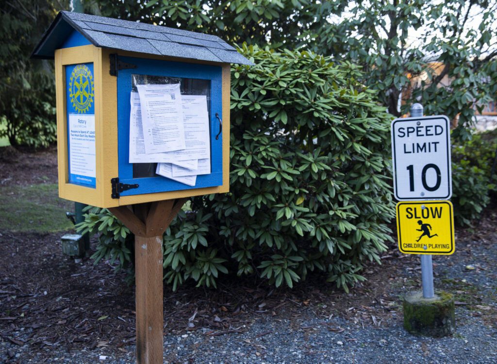 Community notes are posted on a small library as you enter Sherwood Village on Tuesday, Feb. 13, 2024 in Mill Creek, Washington. (Olivia Vanni / The Herald)
