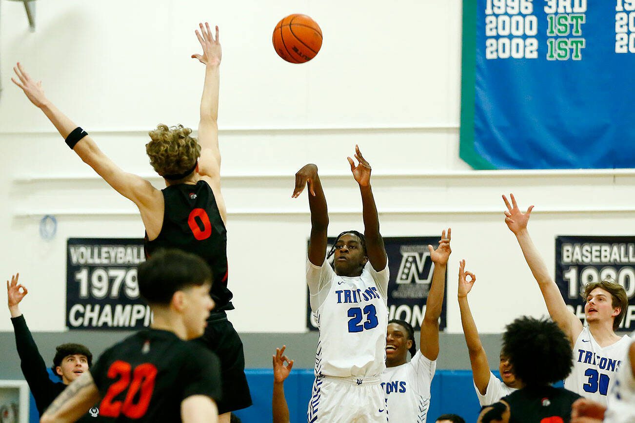 Edmonds College’s Josiah Pierre puts up a three against Everett Community College on Wednesday, Feb. 7, 2024, at Seaview Gym in Lynnwood, Washington. (Ryan Berry / The Herald)