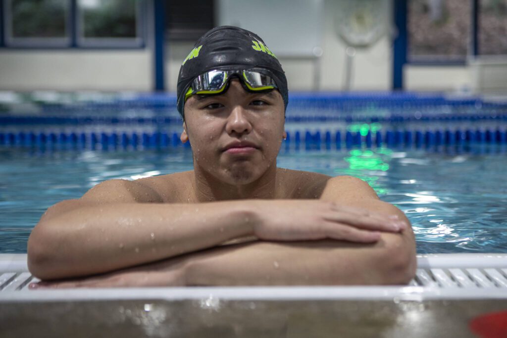 Jackson High School swimmer Vyron Domingo poses for a photo on Wednesday, Feb. 7, 2024 at West Coast Aquatics in Bothell, Washington. (Annie Barker / The Herald)
