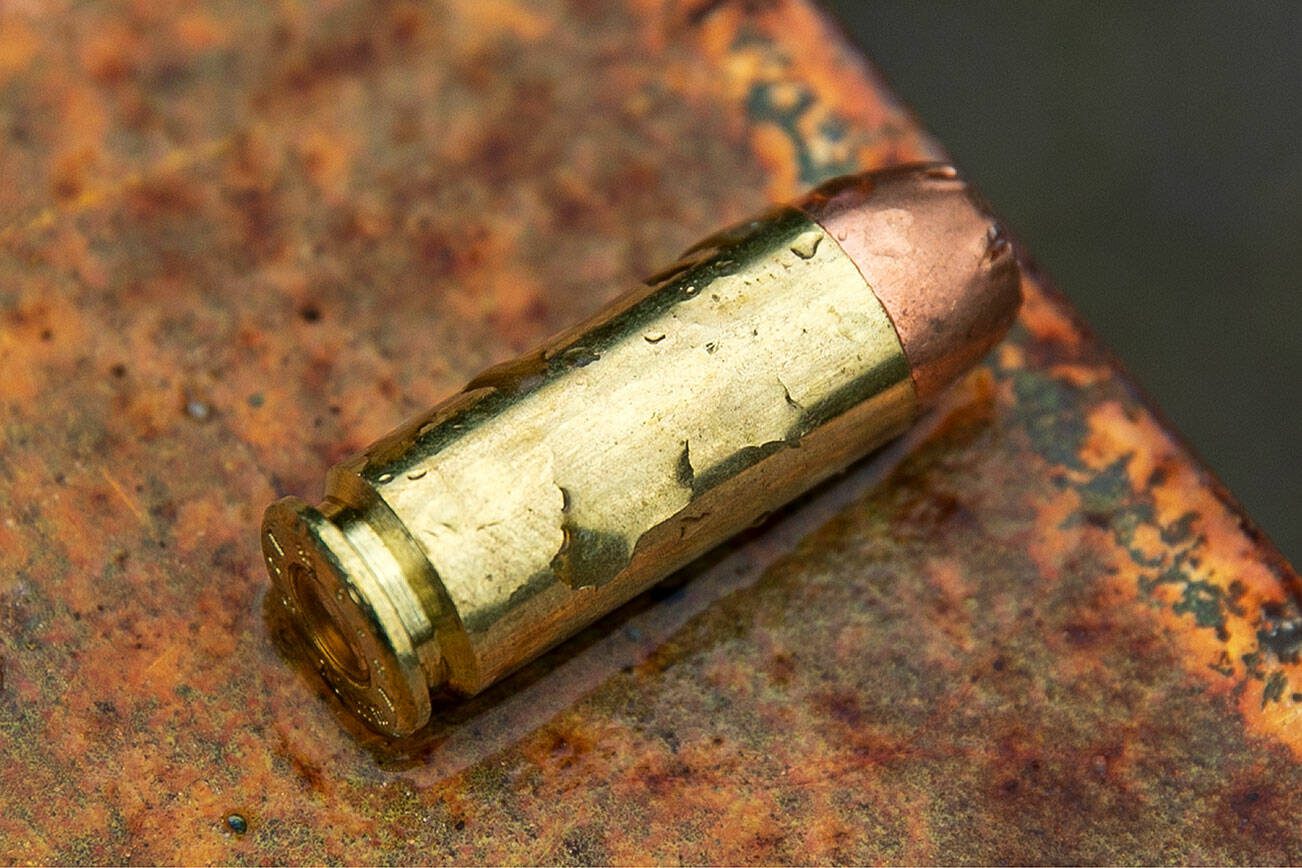 A 10mm round sits on a gate at an unsanctioned shooting put along Sultan Basin Road near Spada Lake on Thursday, Feb. 8, 2024, in Sultan, Washington. (Ryan Berry / The Herald)