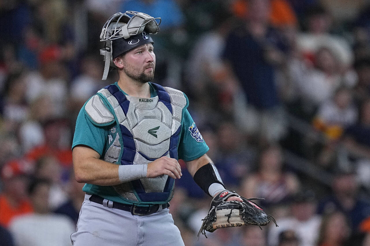 Seattle Mariners catcher Cal Raleigh signals during a game against the Houston Astros on Aug. 19, 2023, in Houston. (AP Photo/Kevin M. Cox)