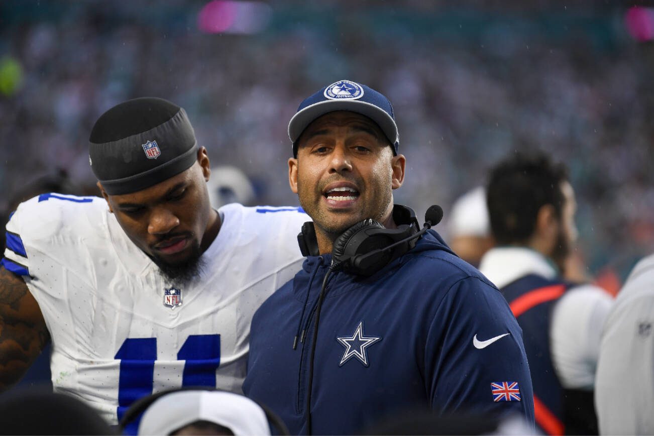 Dallas Cowboys coach Aden Durde talks to his players during the first half of an NFL football game against the Miami Dolphins, Sunday, Dec. 24, 2023, in Miami Gardens, Fla. (AP Photo/Michael Laughlin)