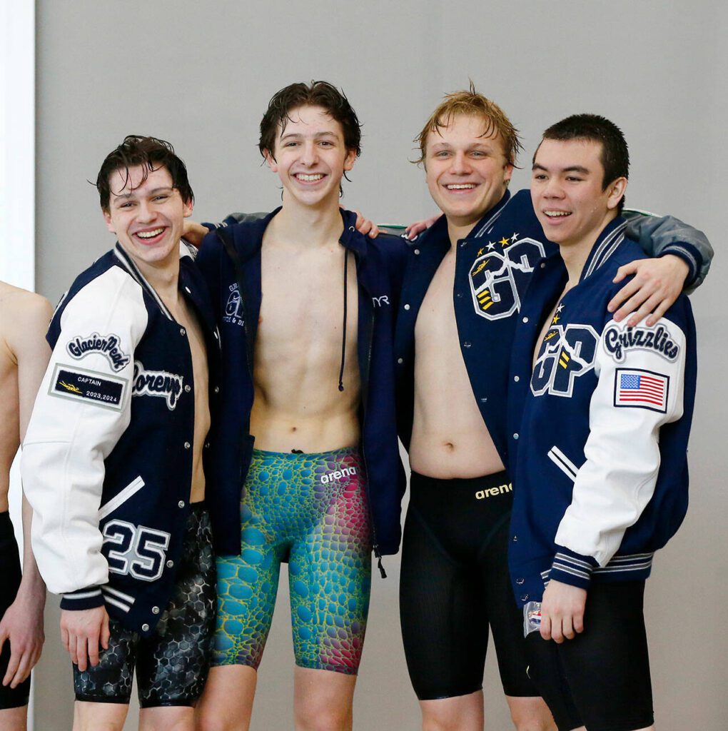 The Glacier Peak boys celebrate a victory in the 400-yard freestyle relay during the Class 4A District 1 swim and dive championships Saturday at the Snohomish Aquatic Center in Snohomish. (Ryan Berry / The Herald)
