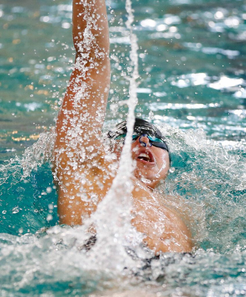 Jackson&rsquo;s Vyron Domingo heads to the finish in the 100-yard backstroke during the Class 4A District 1 swim and dive championships Saturday at the Snohomish Aquatic Center in Snohomish. (Ryan Berry / The Herald)
