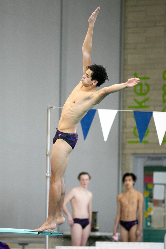 Kamiak junior Zack Warren competes in diving during the Class 4A District 1 swim and dive championships Saturday at the Snohomish Aquatic Center in Snohomish. (Ryan Berry / The Herald)
