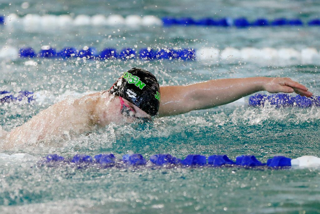 Jackson senior Ethan Georgiev swims in the 100-yard freestyle during the Class 4A District 1 swim and dive championships Saturday at the Snohomish Aquatic Center in Snohomish. (Ryan Berry / The Herald)
