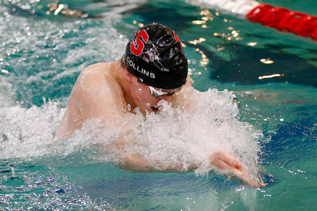Snohomish junior Owen Collins swims to a victory in the 100 yard breaststroke during the Class 3A District 1 swim and dive meet Saturday at the Snohomish Aquatic Center in Snohomish. (Ryan Berry / The Herald)
