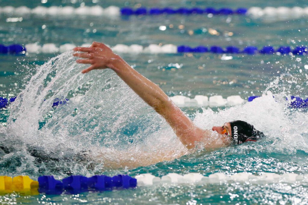 Cascade’s Yurii Onofriichuk swims in the 100 yard backstroke during the Class 3A District 1 swim and dive meet Saturday at the Snohomish Aquatic Center in Snohomish. (Ryan Berry / The Herald)
