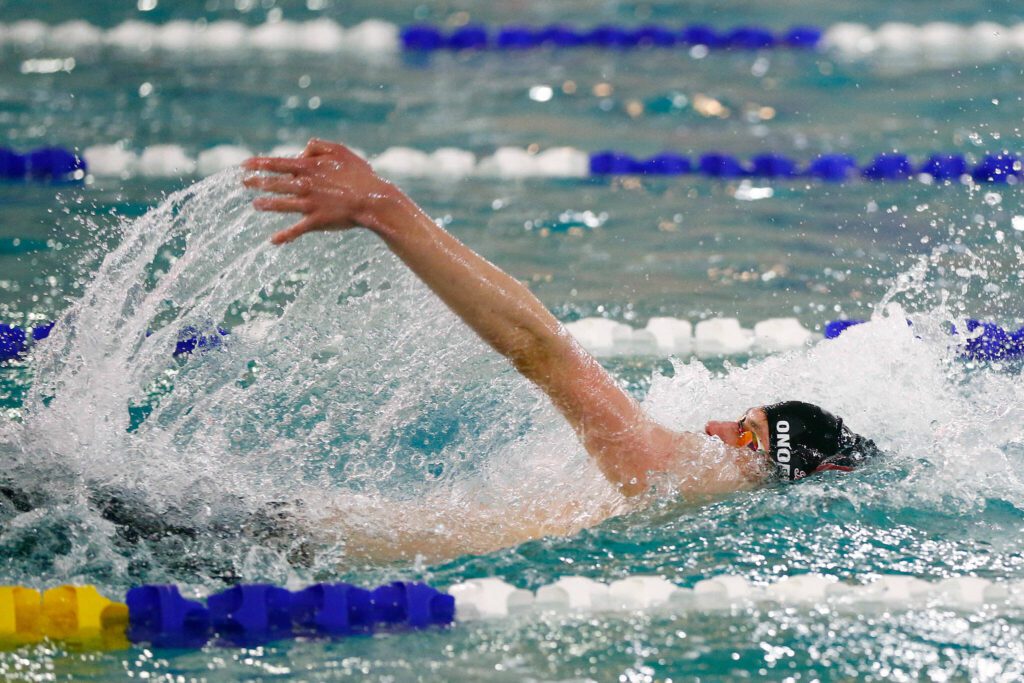 Cascade’s Yurii Onofriichuk swims in the 100 yard backstroke during the Class 3A District 1 swim and dive meet Saturday at the Snohomish Aquatic Center in Snohomish. (Ryan Berry / The Herald)
