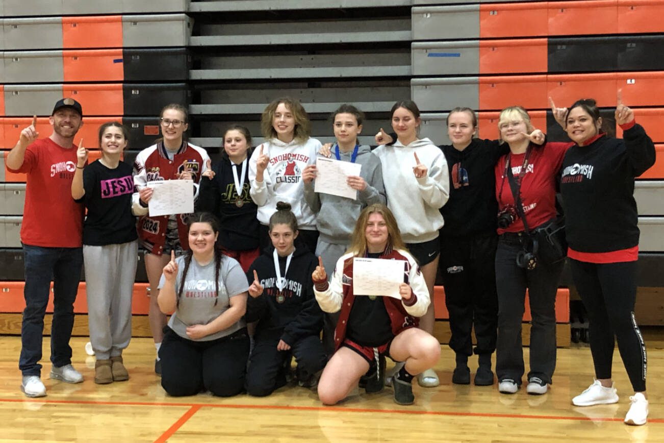 The Snohomish girls wrestling team poses for a photo after winning a share of the regional championship after the Class 3A/4A Girls Region 1 Tournament on Saturday, Feb. 10, 2024, at Monroe High School in Monroe, Washington.