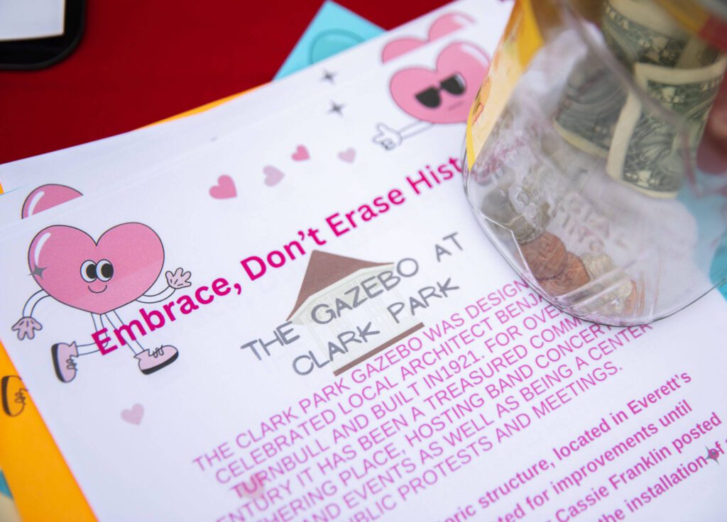 Flyers provide information on the history of the Clark Park gazebo during a “heart bomb” event hosted by Historic Everett on Saturday, Feb. 17, 2024 in Everett, Washington. (Olivia Vanni / The Herald)
