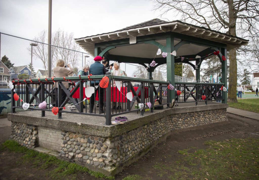 People gather to support saving the Clark Park gazebo during a “heart bomb” event hosted by Historic Everett on Saturday, Feb. 17, 2024 in Everett, Washington. (Olivia Vanni / The Herald)
