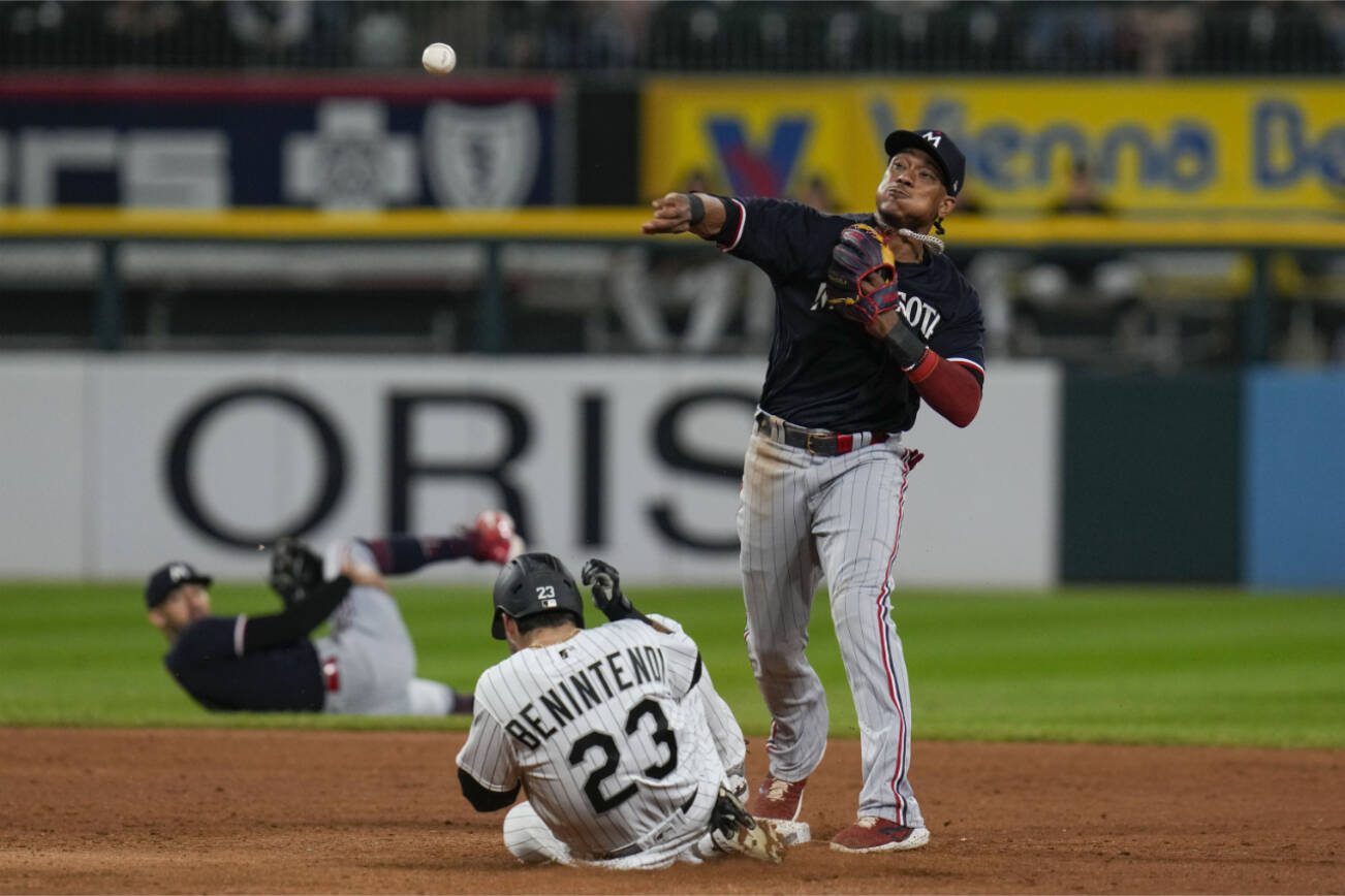 Minnesota Twins second baseman Jorge Polanco, right, tags out Chicago White Sox's Andrew Benintendi at second and throws to first baseman Kyle Farmer to tag out Luis Robert Jr. for the double play during the seventh inning of a baseball game, Saturday, Sept. 16, 2023, in Chicago. (AP Photo/Erin Hooley)