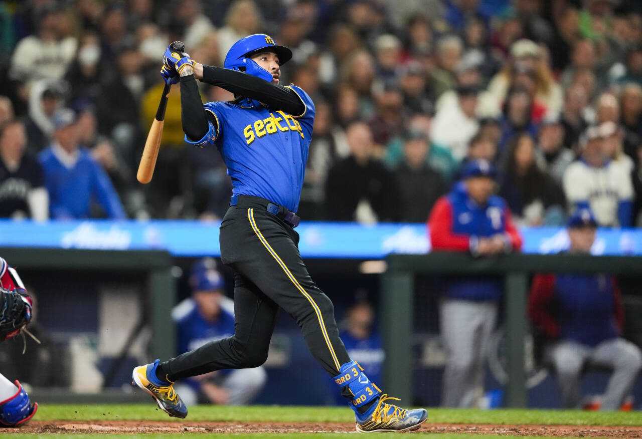 Seattle Mariners’ J.P. Crawford watches his grand slam against the Texas Rangers during the fourth inning of a game Sept. 29, 2023, in Seattle. (AP Photo/Lindsey Wasson)