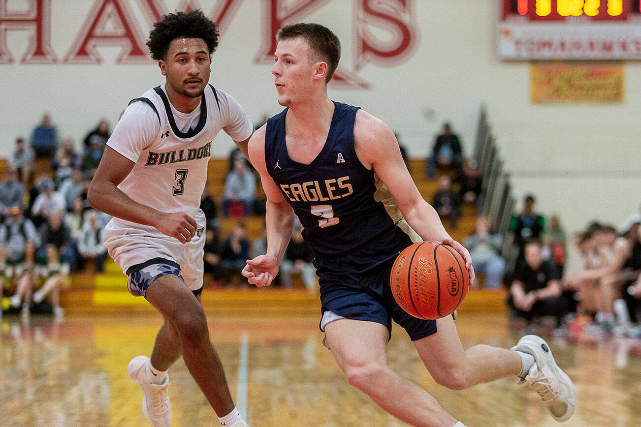 Arlington’s Jackson Trotter drives to the hoop during the game against Mount Vernon on Tuesday, Feb. 13, 2024 in Marysville, Washington. (Olivia Vanni / The Herald)