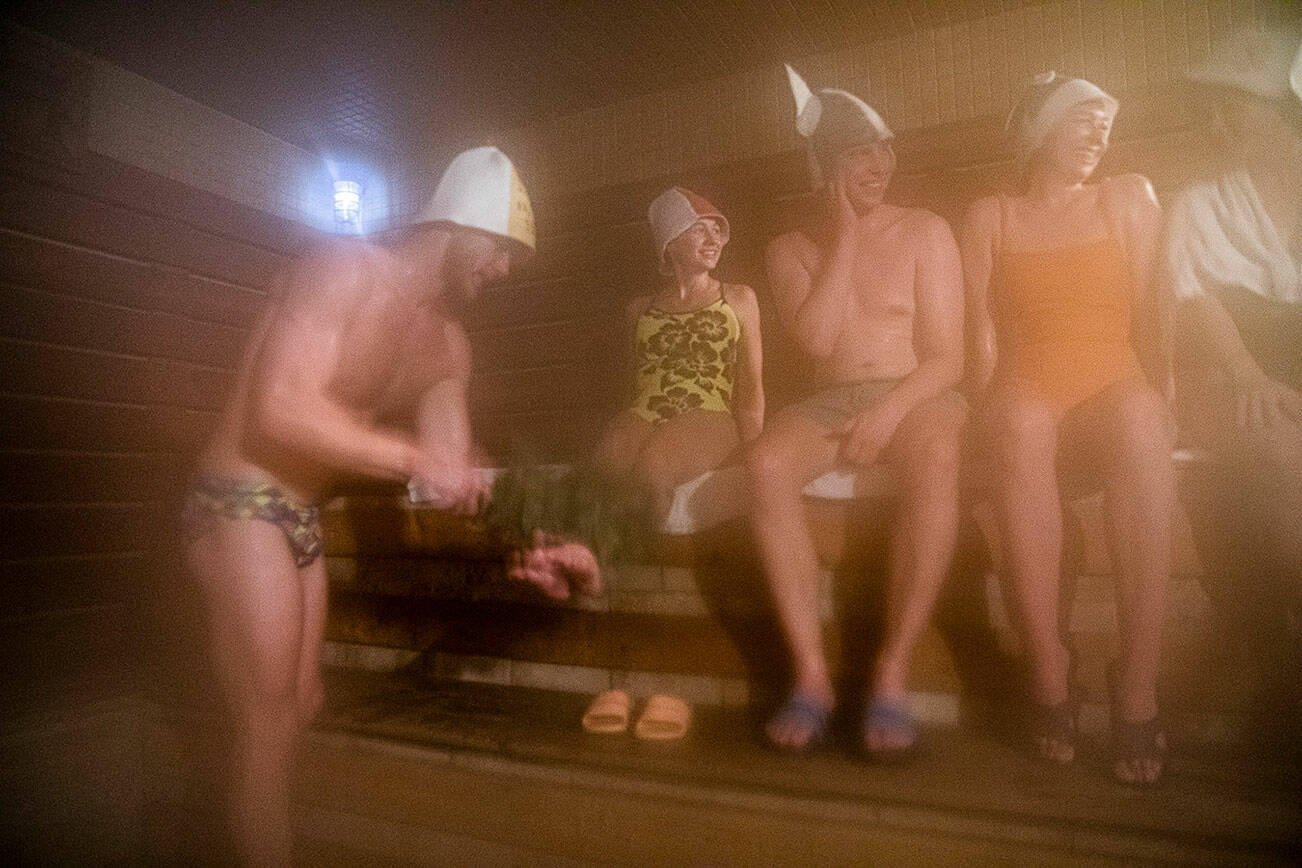 A group of friends hang out in a banya, a Russian sauna that is typically more humid and hotter than a traditional sauna, at Banya by fgm on Monday, Oct. 16, 2023 in Everett, Washington. (Olivia Vanni / The Herald)
