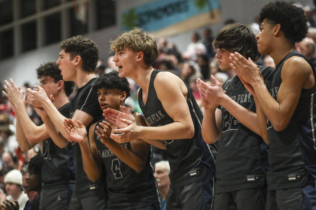 Glacier Peak players cheer during a boys Class 4A bi-district title game between Glacier Peak and Mount Si at North Creek High School on Friday, Feb. 16, 2024 in Bothell, Washington. The Wildcats won, 59-53.(Annie Barker / The Herald)
