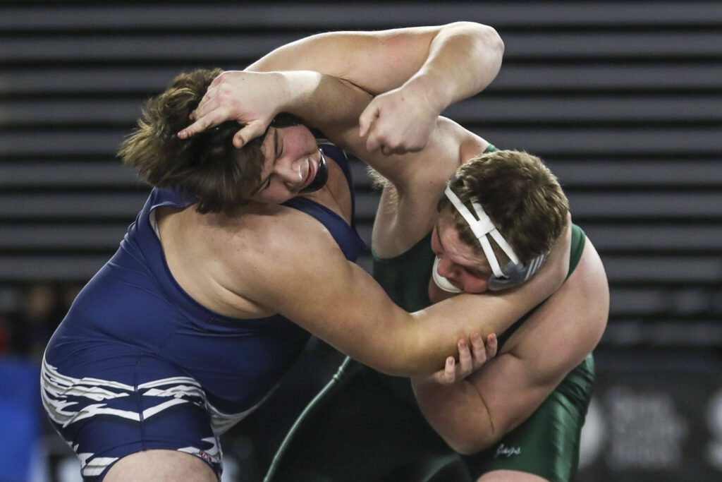 Glacier Peak’s Connor Aney and Emerald Ridge’s Jesse Mains wrestle during the 4A boys 285-pound championship match during Mat Classic XXXV on Saturday, Feb. 17, 2024, at the Tacoma Dome in Tacoma. (Annie Barker / The Herald)
