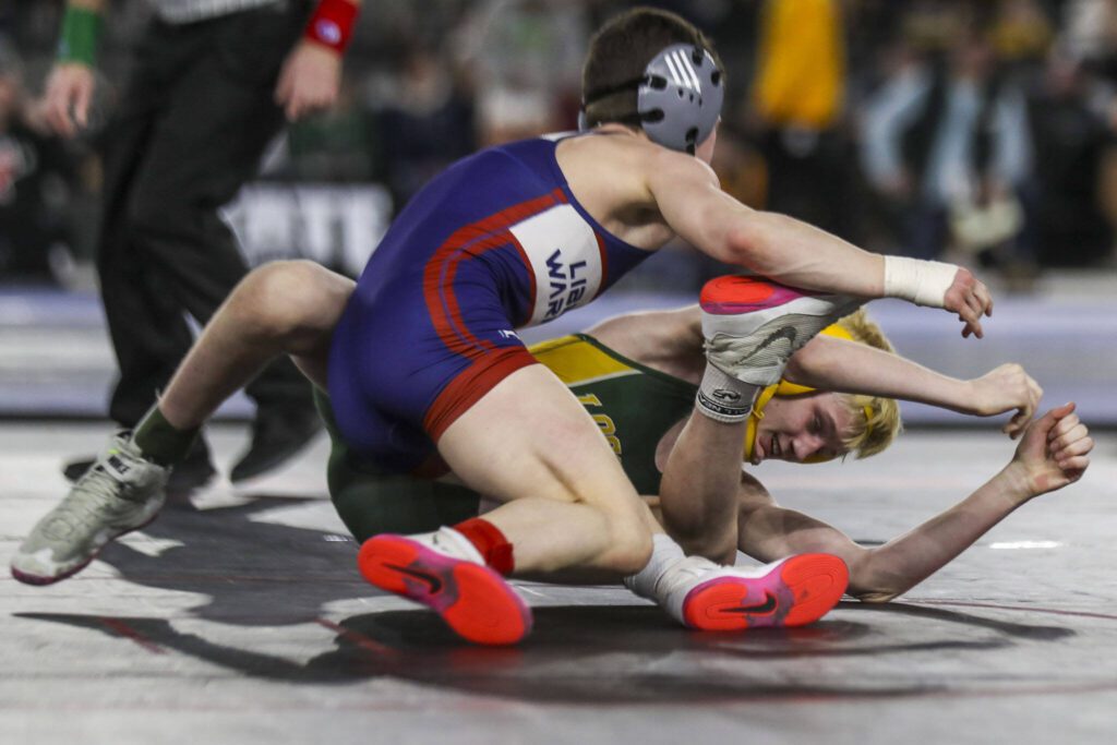 Darrington’s Creed Wright and Liberty Launch Academy’s Caiden Kassel wrestle during the 1B/2B boys 113-pound championship match during Mat Classic XXXV on Saturday, Feb. 17, 2024, at the Tacoma Dome in Tacoma. (Annie Barker / The Herald)
