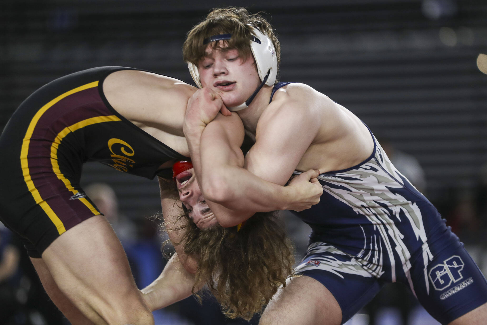 Glacier Peak’s Gil Mossburg and Moses Lake's Dayton Regan wrestle during the 4A boys 150-pound championship match during Mat Classic XXXV on Saturday, Feb. 17, 2024, at the Tacoma Dome in Tacoma. (Annie Barker / The Herald)