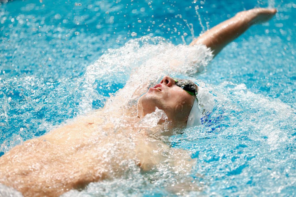 Shorewood senior Ben Allen swims to the wall in the 100 yard backstroke final during the WIAA 3A Boys Swim and Dive Championships on Saturday, Feb. 17, 2024, at the Weyerhaeuser King County Aquatic Center in Federal Way, Washington. (Ryan Berry / The Herald)
