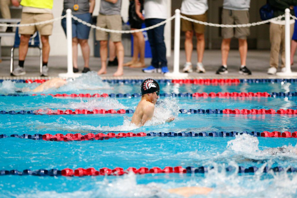 Stanwood junior Lloyd Hau swims in the 100 yard breaststroke consolation during the WIAA 3A Boys Swim and Dive Championships on Saturday, Feb. 17, 2024, at the Weyerhaeuser King County Aquatic Center in Federal Way, Washington. (Ryan Berry / The Herald)

