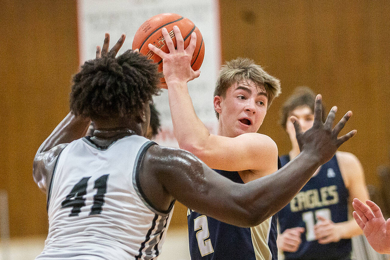 Arlington’s Leyton Martin looks for an open teammate to pass to during the 3A boys district championship game against Mountlake Terrace on Saturday, Feb. 17, 2024 in Marysville, Washington. (Olivia Vanni / The Herald)