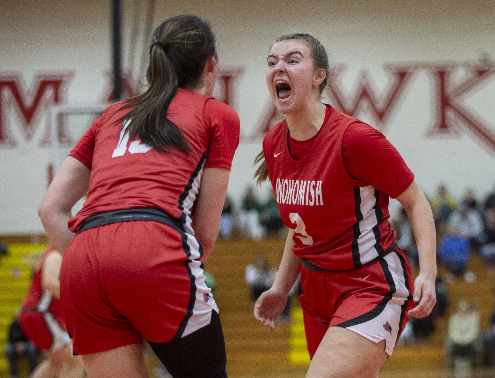 Snohomish’s Kendall Hammer yells in celebration after her teammate scores two and draws a foul call during the 3A girls district championship game against Arlington on Saturday, Feb. 17, 2024 in Marysville, Washington. (Olivia Vanni / The Herald)