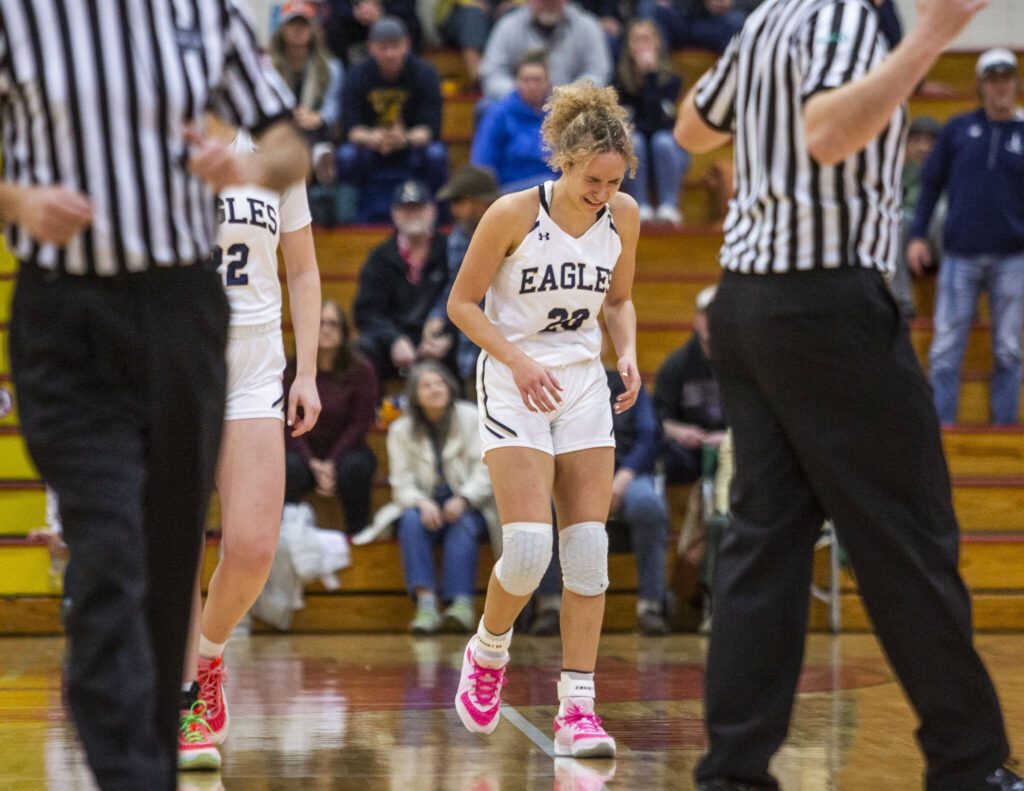 Arlington’s Samara Morrow begins crying after colliding with a Snohomish player in the final seconds of a tied 3A girls district championship game on Saturday, Feb. 17, 2024 in Marysville, Washington. EDITOR’S NOTE: This caption has been corrected. A previous version erroneously stated Morrow committed a foul. (Olivia Vanni / The Herald)
