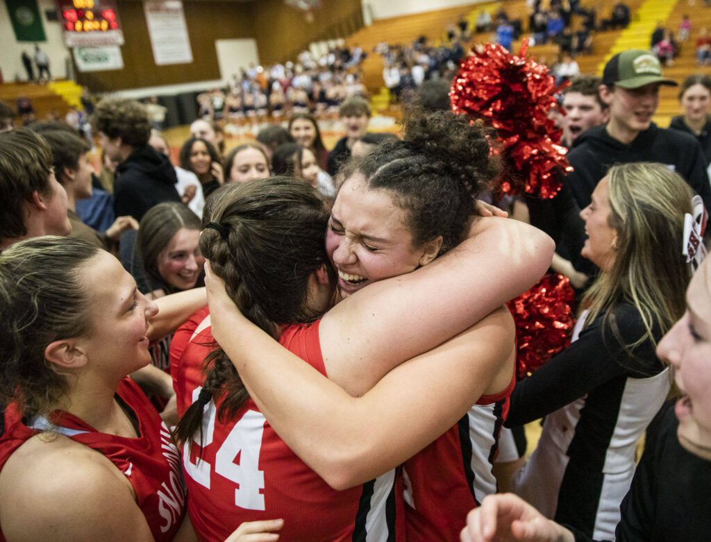 Snohomish’s Addyson Gallatin and Tyler Gildersleeve-Stiles embrace after winning the 3A girls district championship on Saturday, Feb. 17, 2024 in Marysville, Washington. (Olivia Vanni / The Herald)

