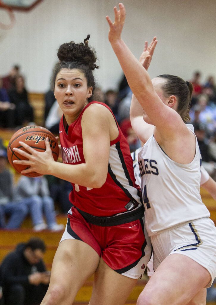 Snohomish’s Tyler Gildersleeve-Stiles tries to maneuver around Arlington’s Katie Snow during the 3A girls district championship game on Saturday, Feb. 17, 2024 in Marysville, Washington. (Olivia Vanni / The Herald)
