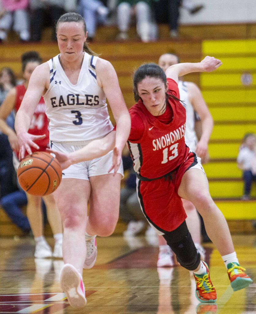 Snohomish’s Sienna Capelli steals the ball from Arlington’s Rachel Snow during the 3A girls district championship game on Saturday, Feb. 17, 2024 in Marysville, Washington. (Olivia Vanni / The Herald)
