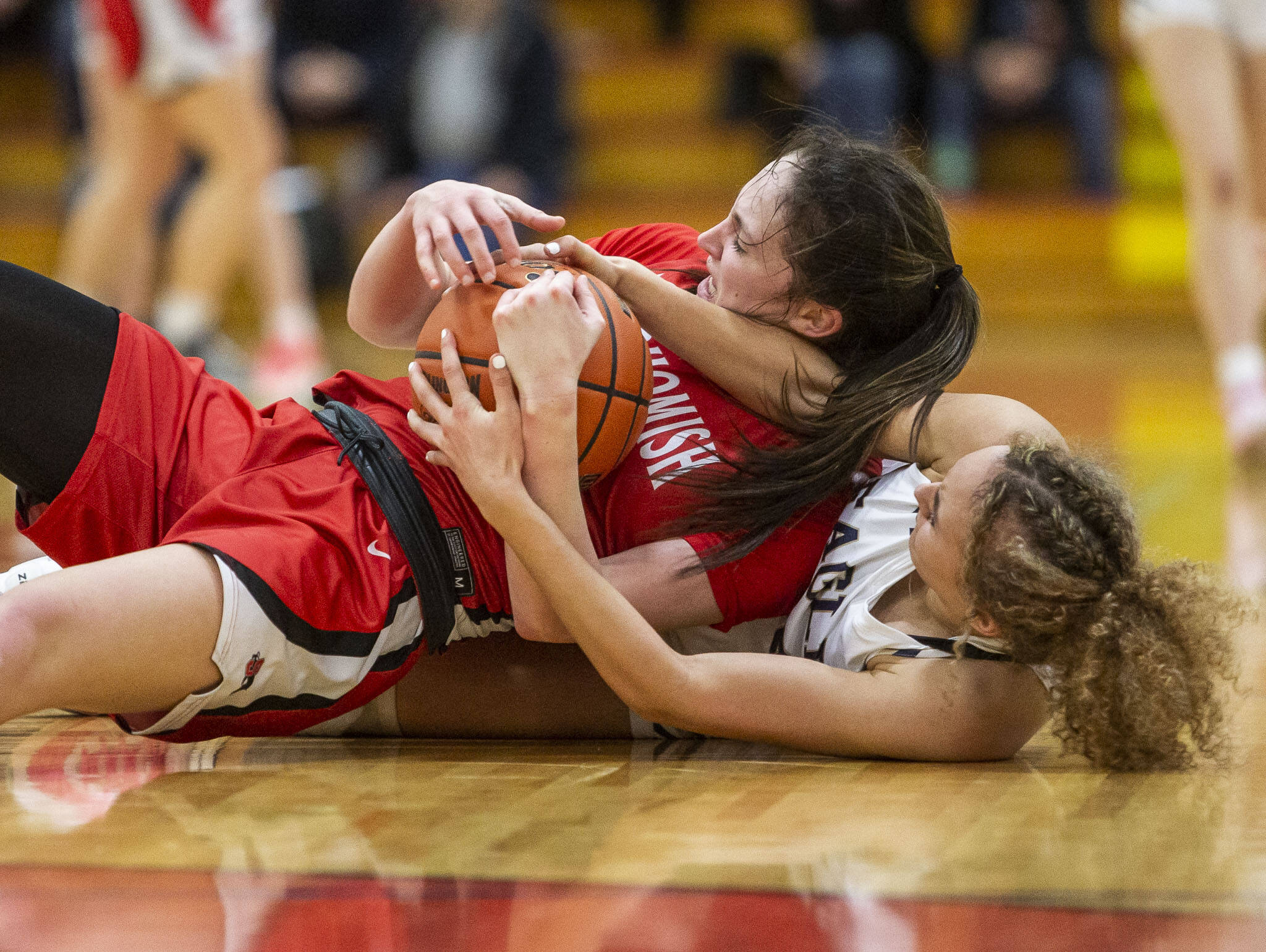 Snohomish’s Sienna Capelli and Arlington’s Samara Morrow scramble for the ball during the 3A girls district championship game on Saturday in Marysville. (Olivia Vanni / The Herald)